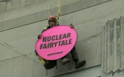 Greenpeace activist hangs from building hosting nuclear summit in Brussels