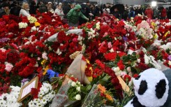 People laid flowers at a makeshift memorial in front of the site of the attack