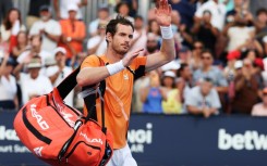 Andy Murray of Great Britain waves to the crowd after losing in three sets against Tomas Machac of the Czech Republic at the Miami Open on Sunday.