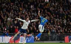 England defender Ben Chilwell (L) in action against Brazil midfielder Raphinha (R) during a recent friendly international at Wembley