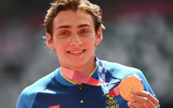 Olympic pole vault champion Armand Duplantis, pictured with his gold medal from the 2020 Tokyo Games, will receive $50,000 if he wins in Paris this year

ce celebrates on the podium with his gold medal after competing in the men's pole vault event during the Tokyo 2020 Olympic Games at the Olympic Stadium in Tokyo on August 4, 2021.