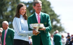 Augusta National chairman Fred Ridley presents Lottie Woad of England with the trophy following the final round of the Augusta National Women's Amateur at Augusta National Golf Club.