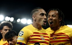 Raphinha (C) celebrates after scoring one of his two goals in Barcelona's 3-2 win over PSG