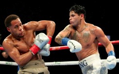 Ryan Garcia (white trunks) punches Devin Haney (gray trunks) on the way to a majority decision victory in their super-lightweight bout in Brooklyn, New York