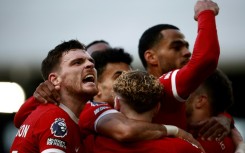 Andy Robertson (left) leads the celebrations after Liverpool's third goal 