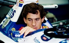 Ayrton Senna adjusts his mirror in the pits at Imola ahead of his last race