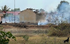 Smoke billows from a warehouse following an explosion at an army base in Cambodia