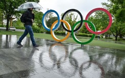 A visitor in the rain at the Japan Olympic Museum in Tokyo