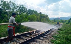 Thai railway workers doused the melting tracks with water to try to bend them back into shape