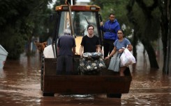 A construction vehicle carries evacuees from a flooded area of the Sao Geraldo neighborhood in Porto Alegre, on May 4, 2024