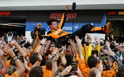 McLaren's Lando Norris is tossed in the air as his team celebrates victory at the Miami Grand Prix on Sunday