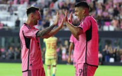 Luis Suarez celebrates with Lionel Messi after scoring his third goal against the New York Red Bulls in Saturday's 6-2 win.