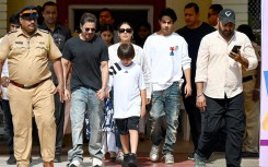 Bollywood actor Shah Rukh Khan (4L) along with his family leaves a polling booth after casting his ballot vote in Mumbai