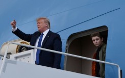 Former US president Donald Trump, pictured with son Barron in 2020, complained that he would be unable to attend the graduation ceremony -- but ultimately was granted a trial recess