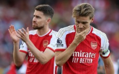 Arsenal's Martin Odegaard (R) and Jorginho (L) react after their title disappointment