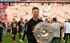 'Outstanding': Bayer Leverkusen coach Xabi Alonso poses with the Bundesliga trophy 