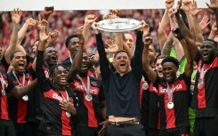 Champions: Bayer Leverkusen coach Xabi Alonso and his players celebrate with the Bundesliga trophy