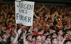 Liverpool fans hold a banner reading "Jurgen Lives Forever" 