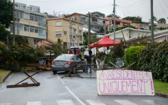 A sign at a roadblock in Portes de Fer district reads 'Residents only!' as a car is checked