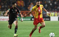 Marwan Attia (L) of Al Ahly challenges Ghaylene Chaalali of Esperance during the first leg of the 2024 CAF Champions League final in Tunisia. 