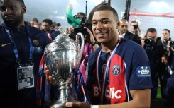 Kylian Mbappe parades the trophy after PSG beat Lyon 2-1 in Saturday's French Cup final 