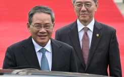 Chinese Premier Li Qiang (L, with South Korea's Vice Foreign Minister Kim Hong-kyun) arrives in Seoul for the summit with Japan and South Korea