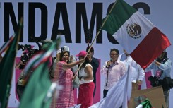 Opposition presidential candidate Xochitl Galvez waves the Mexican flag at a rally in the capital