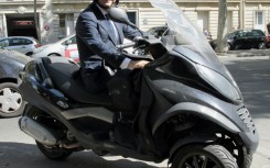 Candidate for the French Socialist Party 2012 primary elections, Francois Hollande is pictured on his scooter in Paris in 2011