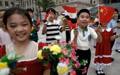 Children cheer as they rehearse for a welcome ceremony for Egyptian President Abdel Fattah al-Sisi at the Great Hall of the People in Beijing