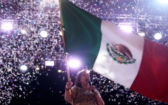 Opposition presidential candidate Xochitl Galvez waves the Mexican flag during a campaign rally