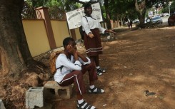 Students wait outside their Government Science Secondary School in the capital after unions launched an indefinite strike for a higher minimum wage