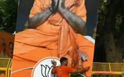 A supporter of India's Prime Minister Narendra Modi carries his portrait on Tuesday as results were announced in the general elections 