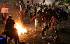 Mounted Israeli police try to disperse a demonstration by relatives and supporters of Israelis held hostage by Palestinian Hamas militants in Gaza since the October 7 attacks, in Tel Aviv early on June 2, 2024