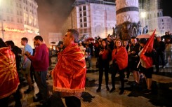 VMRO-DPMNE supporters wrapped in nationalist flags gather to celebrate their party's victory in North Macedonia's elections