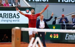 Serbia's Novak Djokovic (L) celebrates the winning point of his five-set victory over Francisco Cerundolo