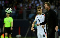 Germany's head coach Julian Nagelsmann (r), flanked by  veteran defender Joshua Kimmich, gives directions against Ukraine 