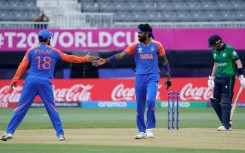 India's Hardik Pandya (C) celebrates with Virat Kohli (L) after taking a wicket in a T20 World Cup match against Ireland in New York