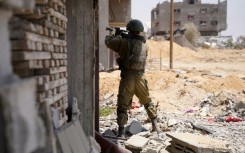 An Israeli soldier takes aim during operations in the Gaza Strip