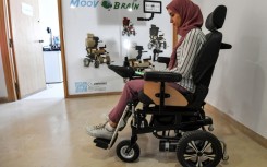 Tunisian engineer Souleima Ben Tamime tests a prototype of her team's new wheelchair system