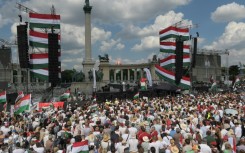 Posters held by the cheering masses read 'Wake up Hungarians' and 'We are masters of our future'