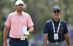 World number one Scottie Scheffler, left, walks with golf instructor Claude Harmon III on the fourth hole during a practice round ahead of Thursday's start of the 124th US Open at Pinehurst