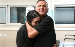 Freed Israeli hostage Noa Argamani, 26, is embraced by her father at a hospital on June 8, 2024