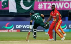 On the run: Pakistan's Mohammad Rizwan makes his ground as Canada's Jeremy Gordon looks on 