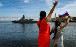 Cubans wave as Russian ships leave the Havana harbor after a five-day visit