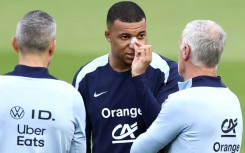 Kylian Mbappe, with a plaster on his broken nose, speaks to France coach Didier Deschamps at the team's Euro 2024 base in Paderborn on Wednesday