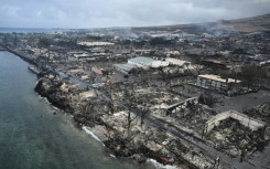 An aerial image shows Old Lahaina Center and Foodland Lahaina standing amongst destroyed homes and businesses along Front Street burned to the ground in the historic Lahaina in the aftermath of wildfires in western Maui in Lahaina, Hawaii 