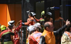 Firefighters at an incident at McLaren's hospitality unit before third practice