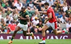 On the attack: South Africa wing Makazole Mapimpi takes on Wales centre Mason Grady at Twickenham 