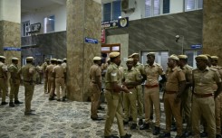 Indian police stand guard in front of a hospital ward caring for patients who consumed toxic illegal alcohol in Tamil Nadu state