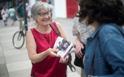 An activist with France's New Popular Front left-wing alliance distributes leaflets in the southern French city of Marseille 